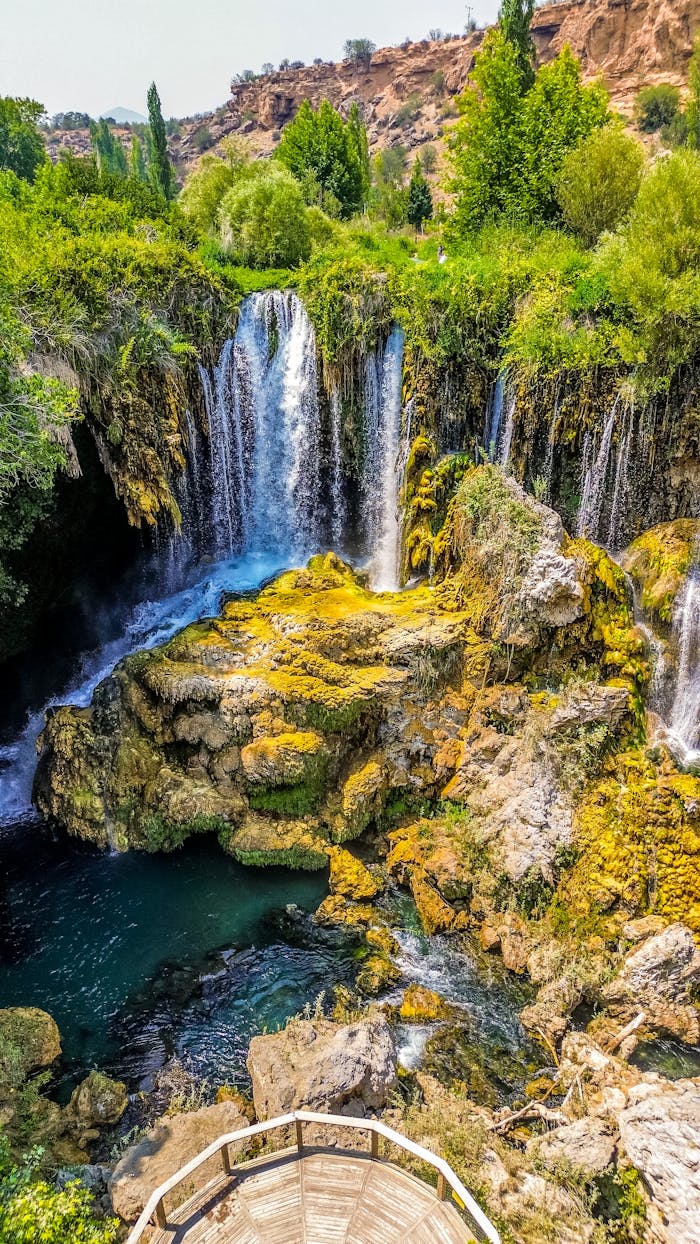 Breathtaking view of a waterfall in Ihlara Valley, Turkey surrounded by lush greenery.